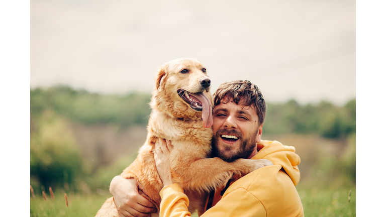 Guy and his dog, golden retriever, nature