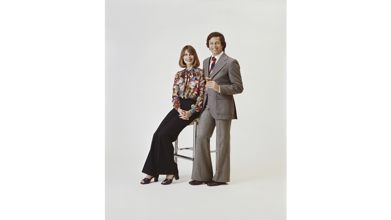 Couple on white background, man holding drink