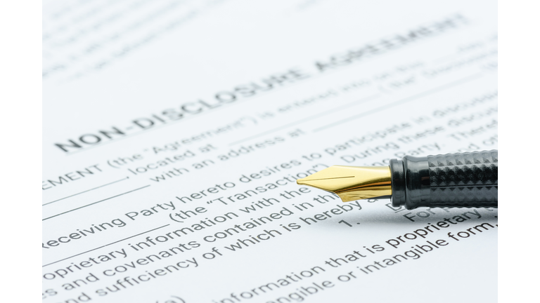 Business legal document concept : Pen on a mutual confidentiality agreement form. Confidentiality agreement is legal contract between 2 or bilateral parties that outlines confidential issues together