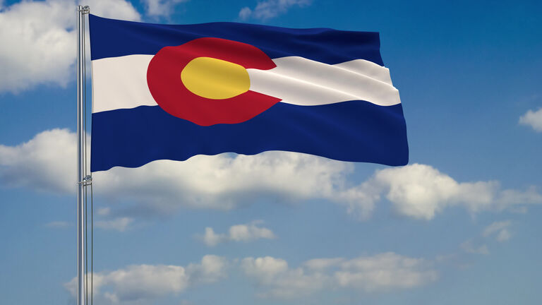 Flag of Colorado - US state fluttering in the wind against a cloudy sky 3d rendering