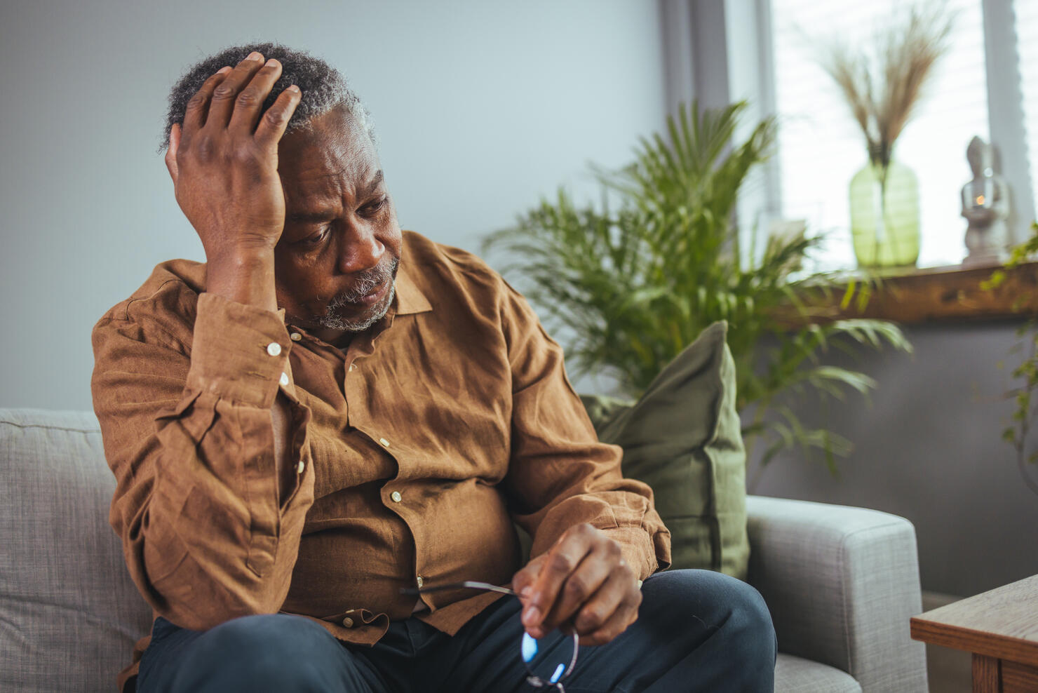 Frustrated unhealthy senior mature man touching head