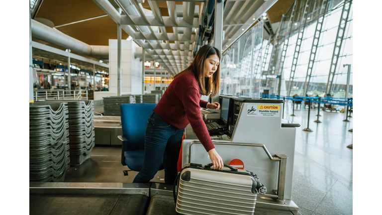 Luggage on weight at check-in counter at airport