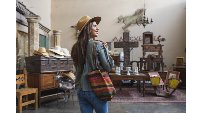 Young woman shopping in antique store