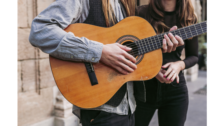 Close-up of two musicians with guitar