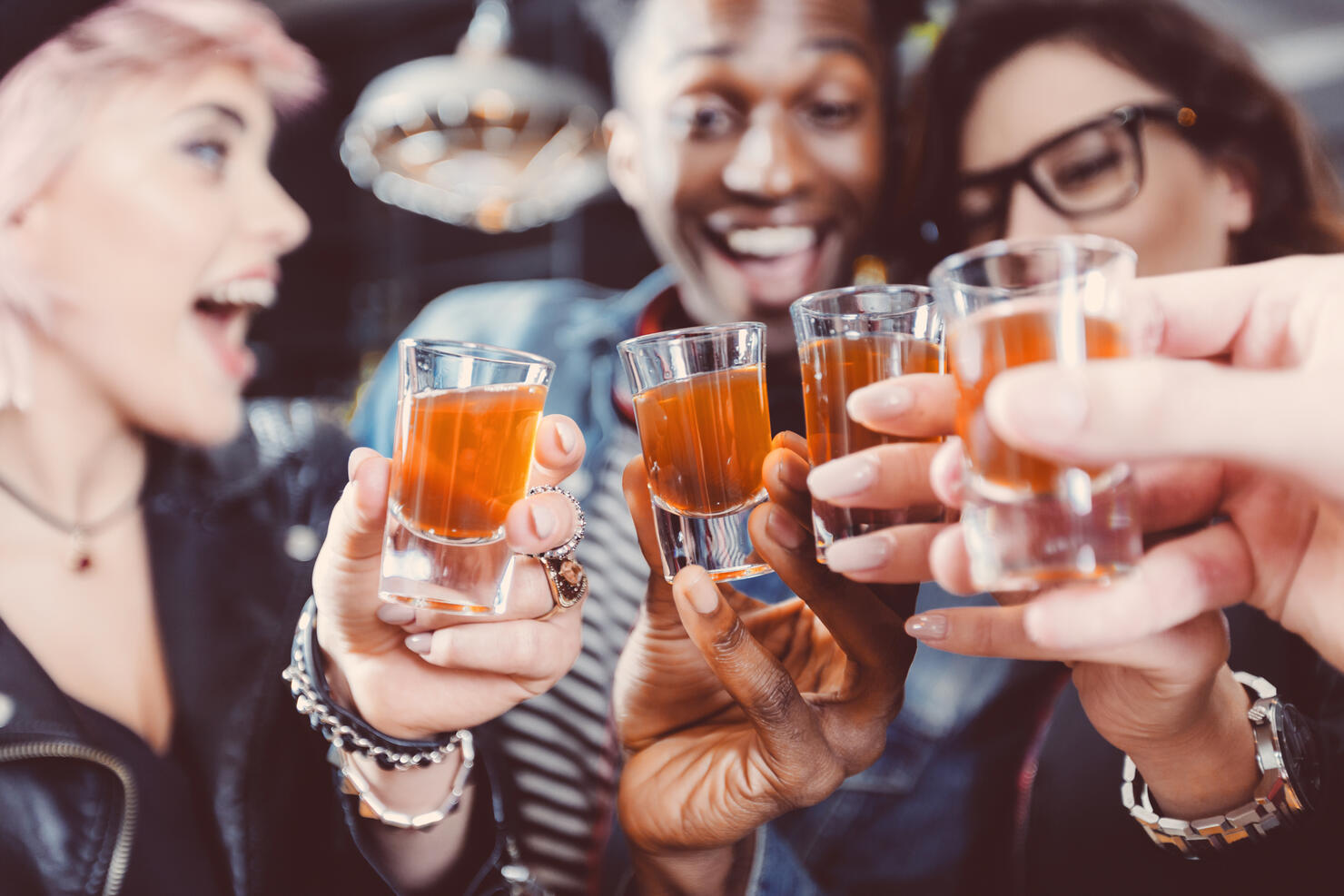 Happy friends drinking shots