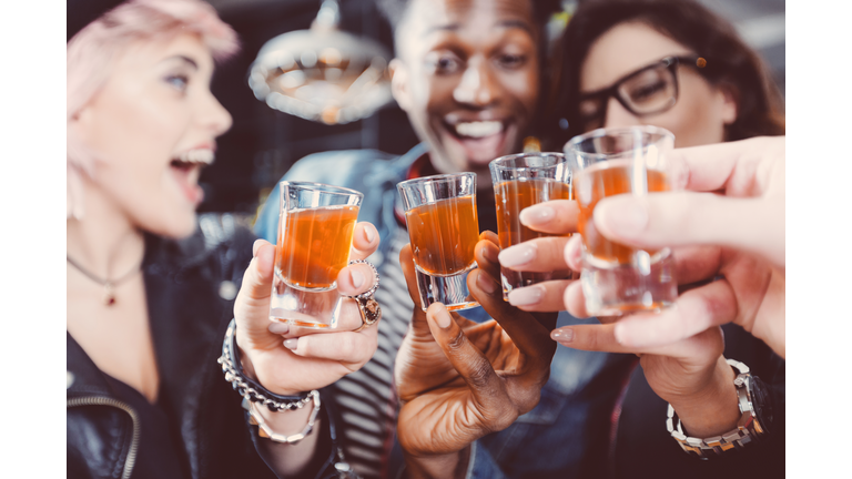 Happy friends drinking shots