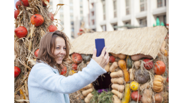 Selfie on the background of pumpkins
