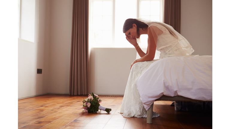 Bride In Bedroom Having Second Thoughts Before Wedding