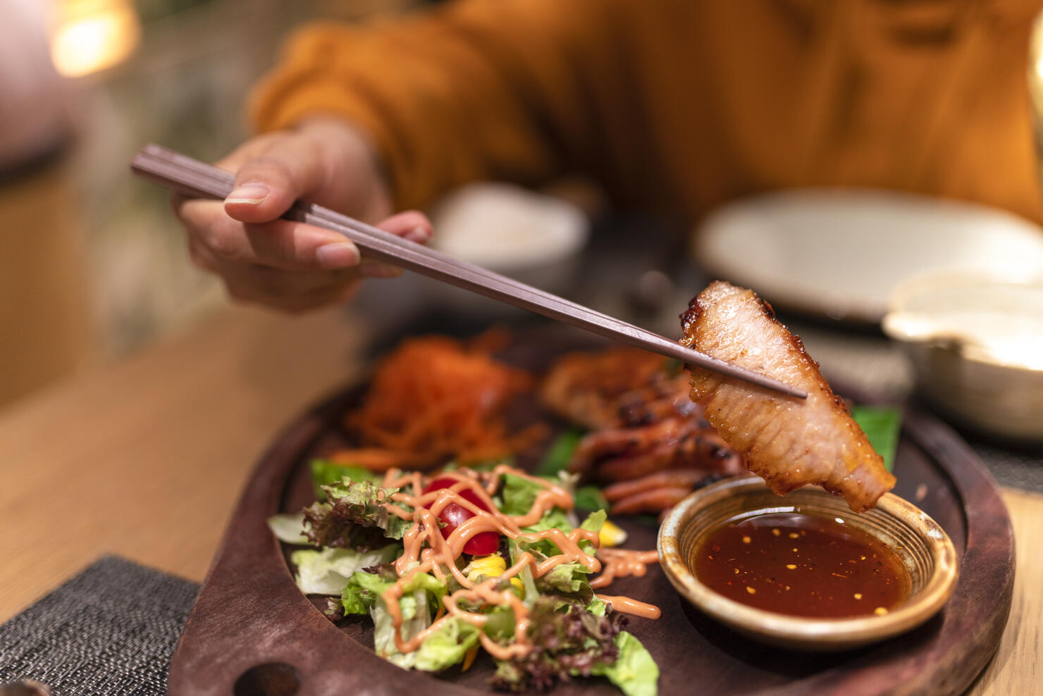 Asian woman tasting Thai food in the restaurant