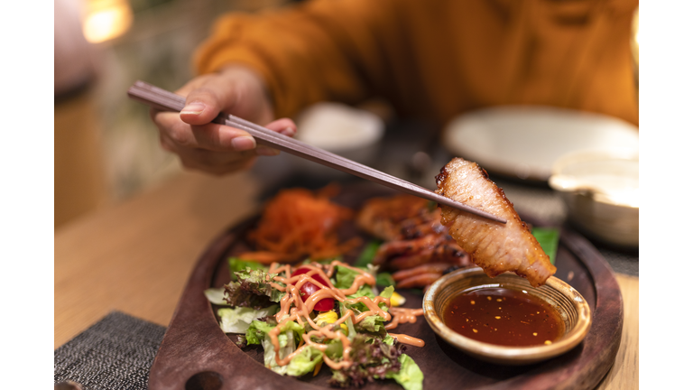 Asian woman tasting Thai food in the restaurant