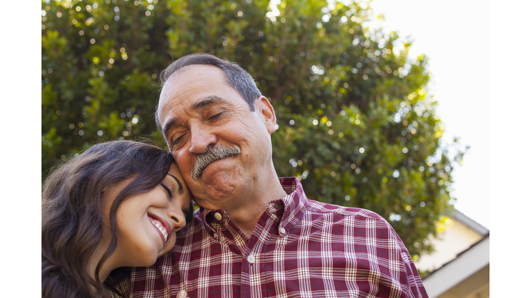 Father and daughter sharing tender moment