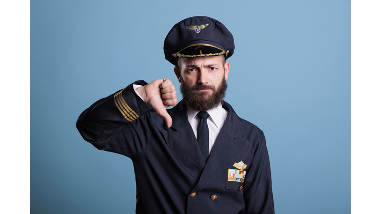 Serious airplane aviator with thumbs down gesture