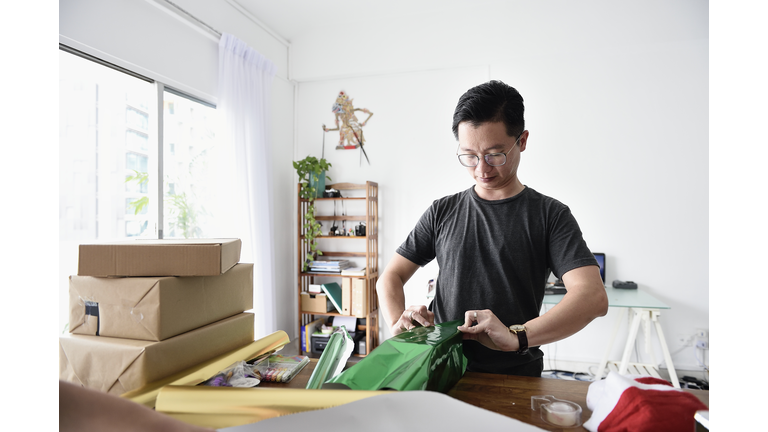 Man wrapping Christmas presents