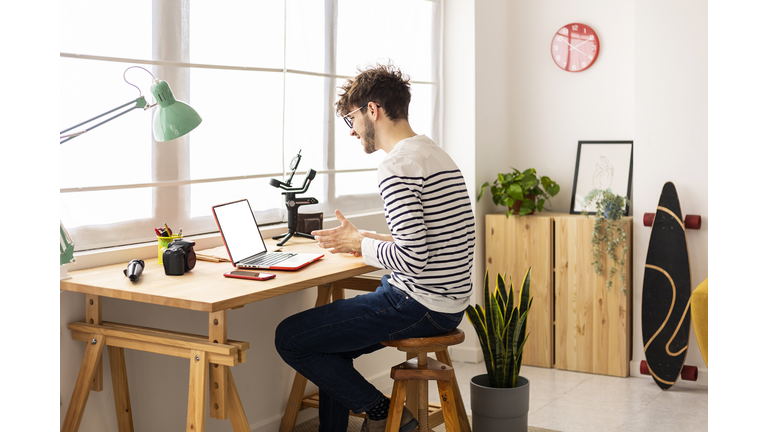 Young using laptop while sitting at a desk