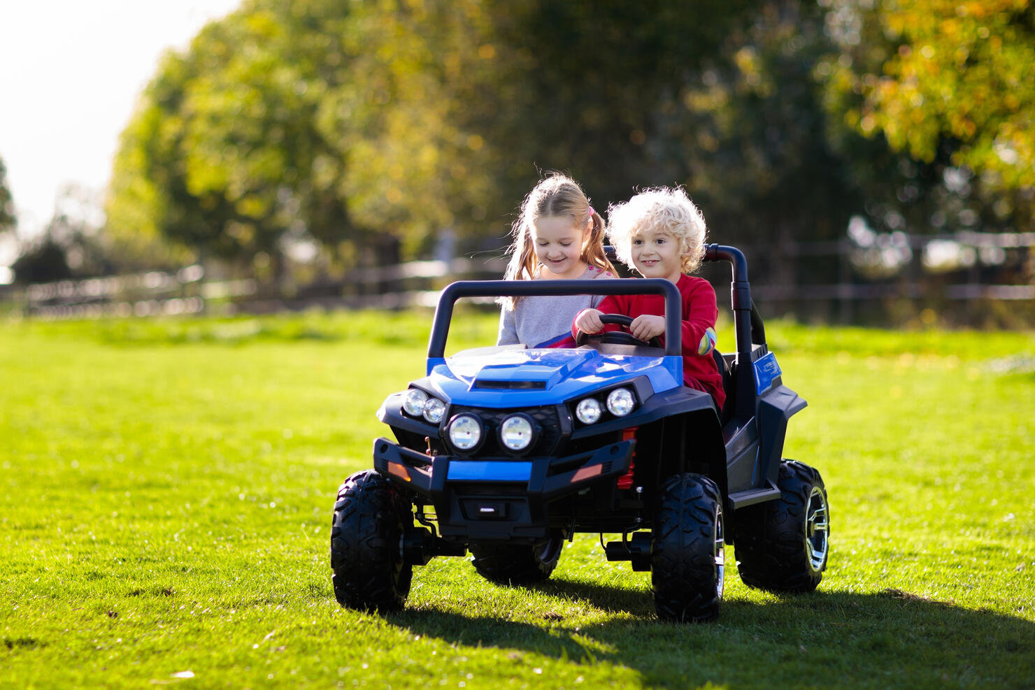 Kids driving electric toy car. Outdoor toys.