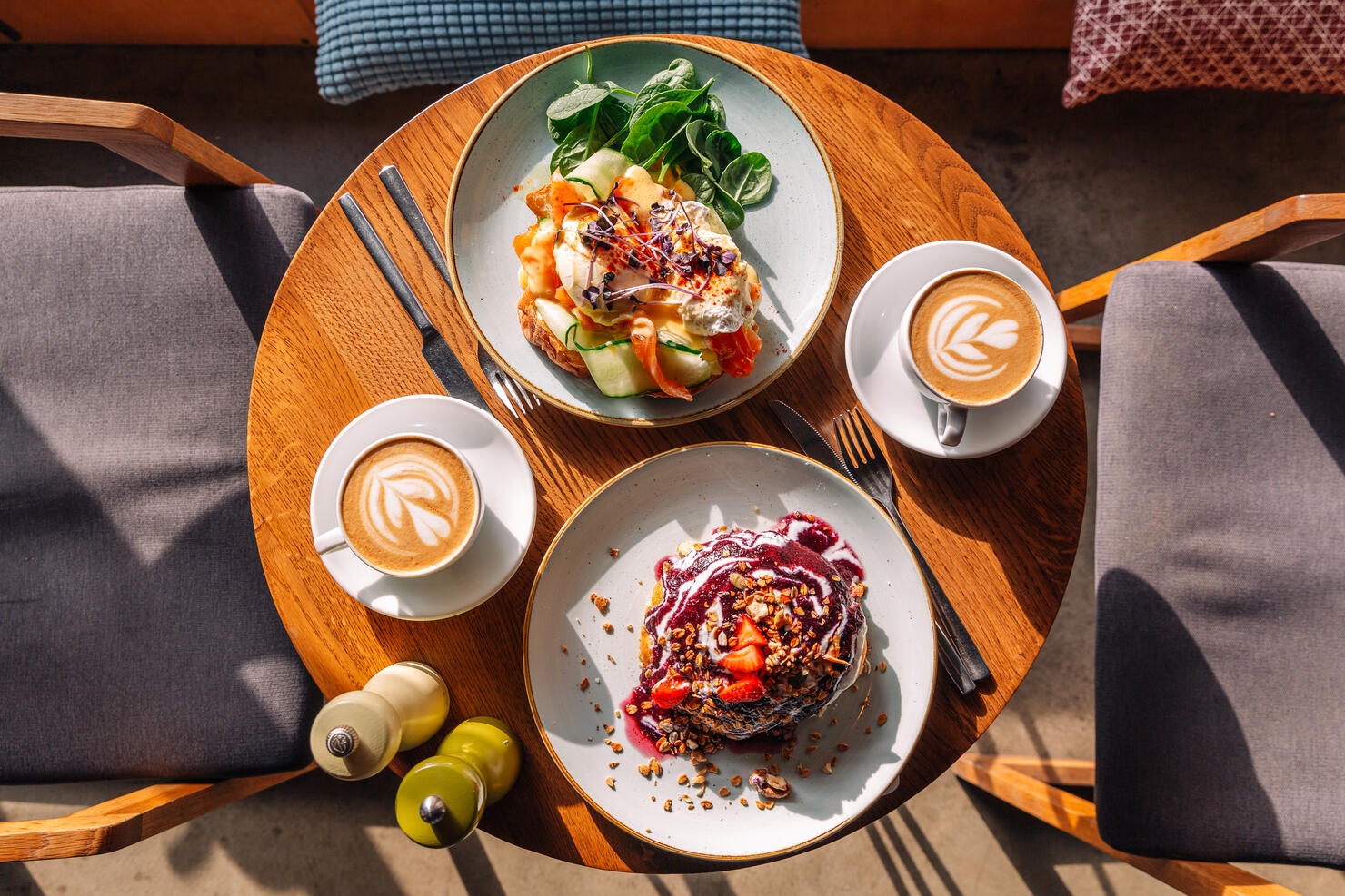 Brunch with sweet pancakes and Eggs Benedict with salmon served in restaurant