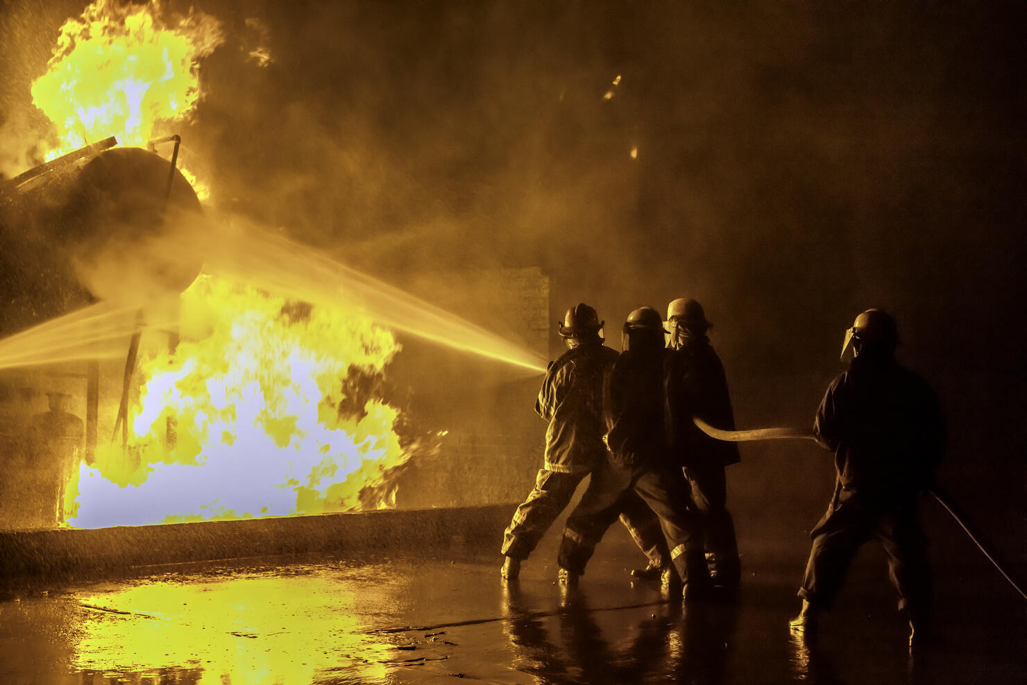 Firefighters extinguishing an industrial fire
