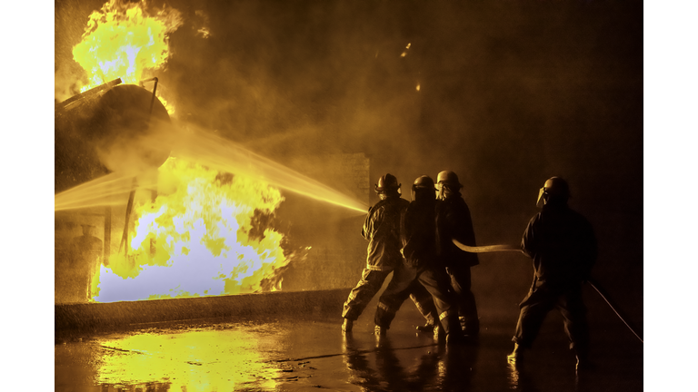 Firefighters extinguishing an industrial fire