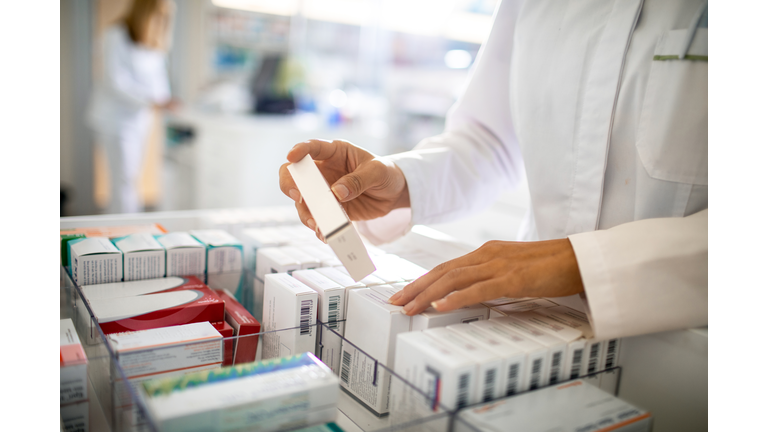 Pharmacist organizing the medicine drawer
