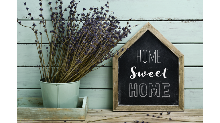 text home sweet home in a house-shaped signboard