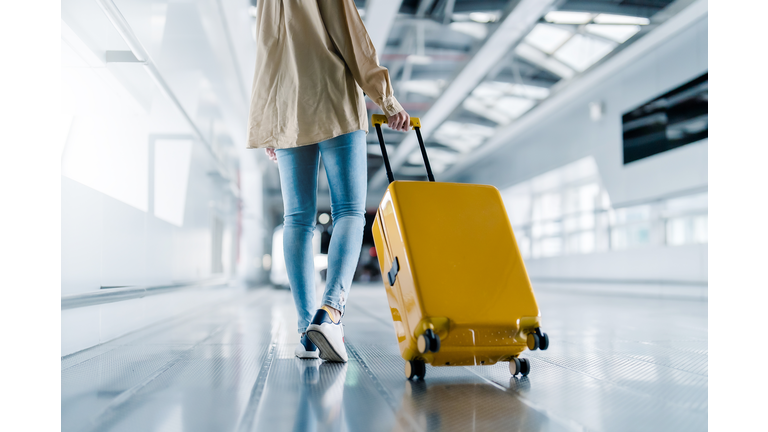 International airport terminal. Asian beautiful woman with luggage and walking in airport