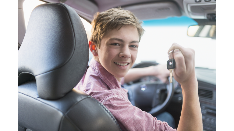 USA, New Jersey, Jersey City, Teenage boy (16-17) driving his first car