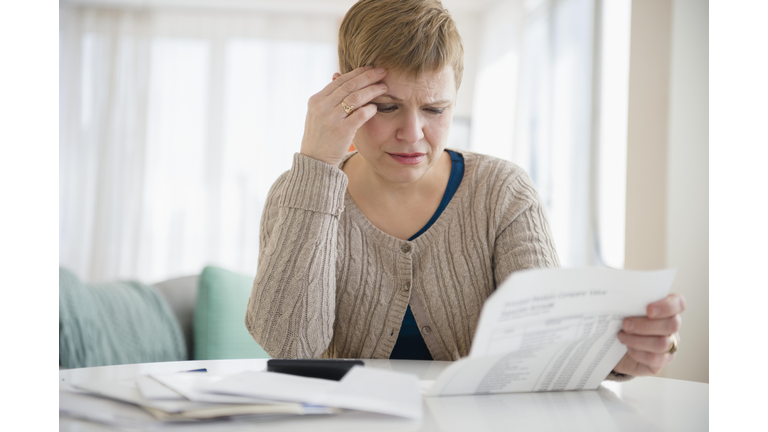 Anxious Caucasian woman paying bills