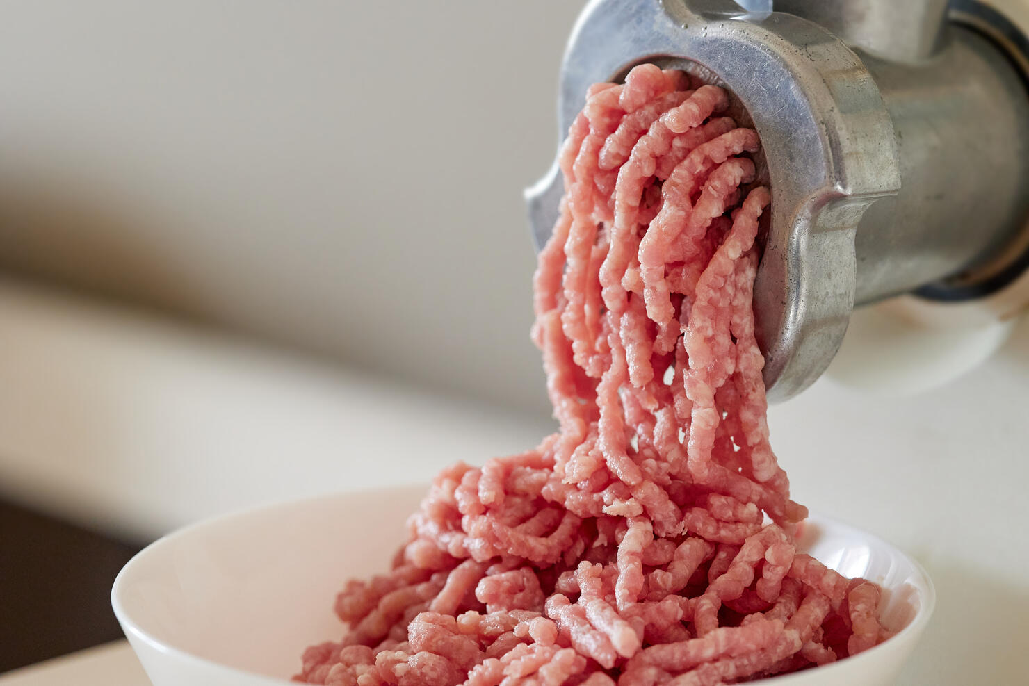 mince the meat with an electric meat mincer