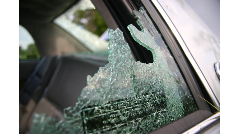 Broken car glass with warning label