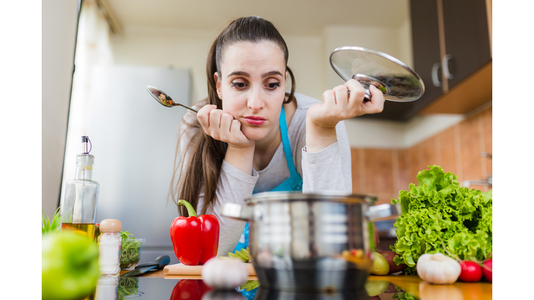 Dissatisfied housewife trying to prepare healthy meal. Cooking learning problems.