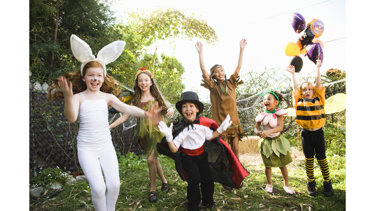 Excited children in Halloween costumes