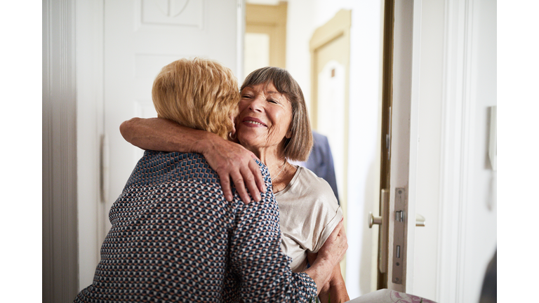 Senior couple visiting friends in their home