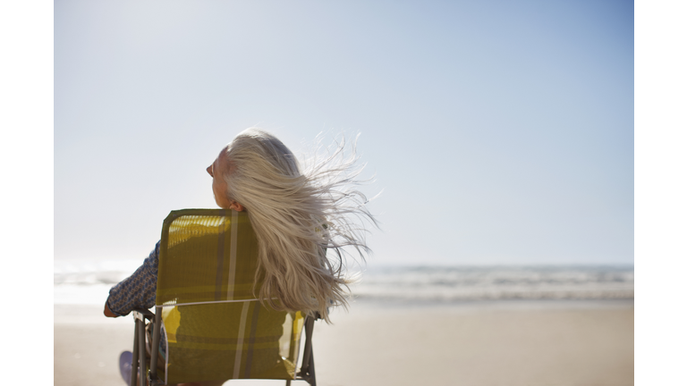 Womans hair blowing in wind on beach