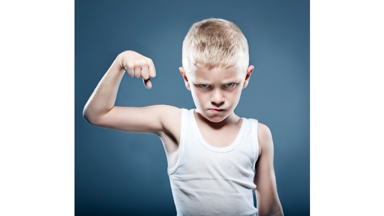 Young child showing his muscles