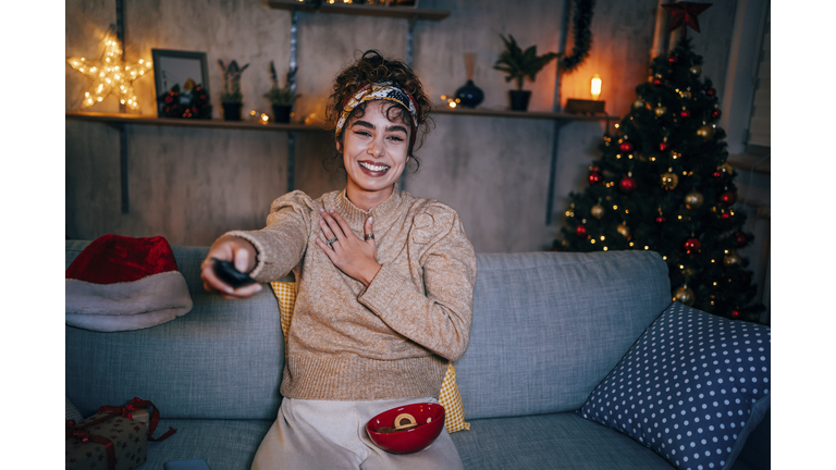 Woman watching tv at home