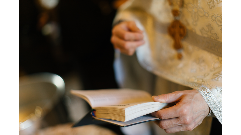 close up of priest's hands - stock photo