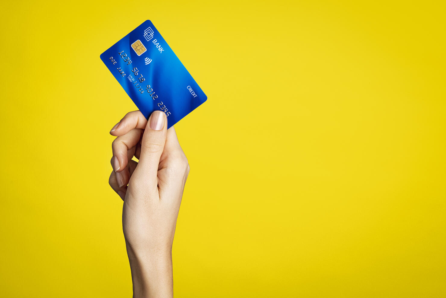 Female hand holding bank credit card
