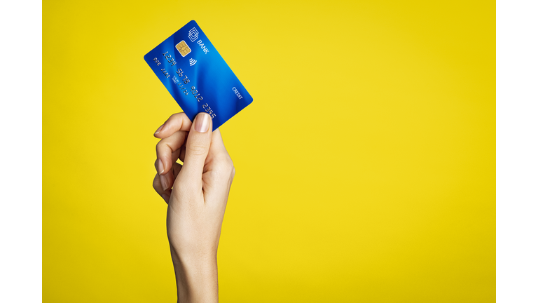 Female hand holding bank credit card