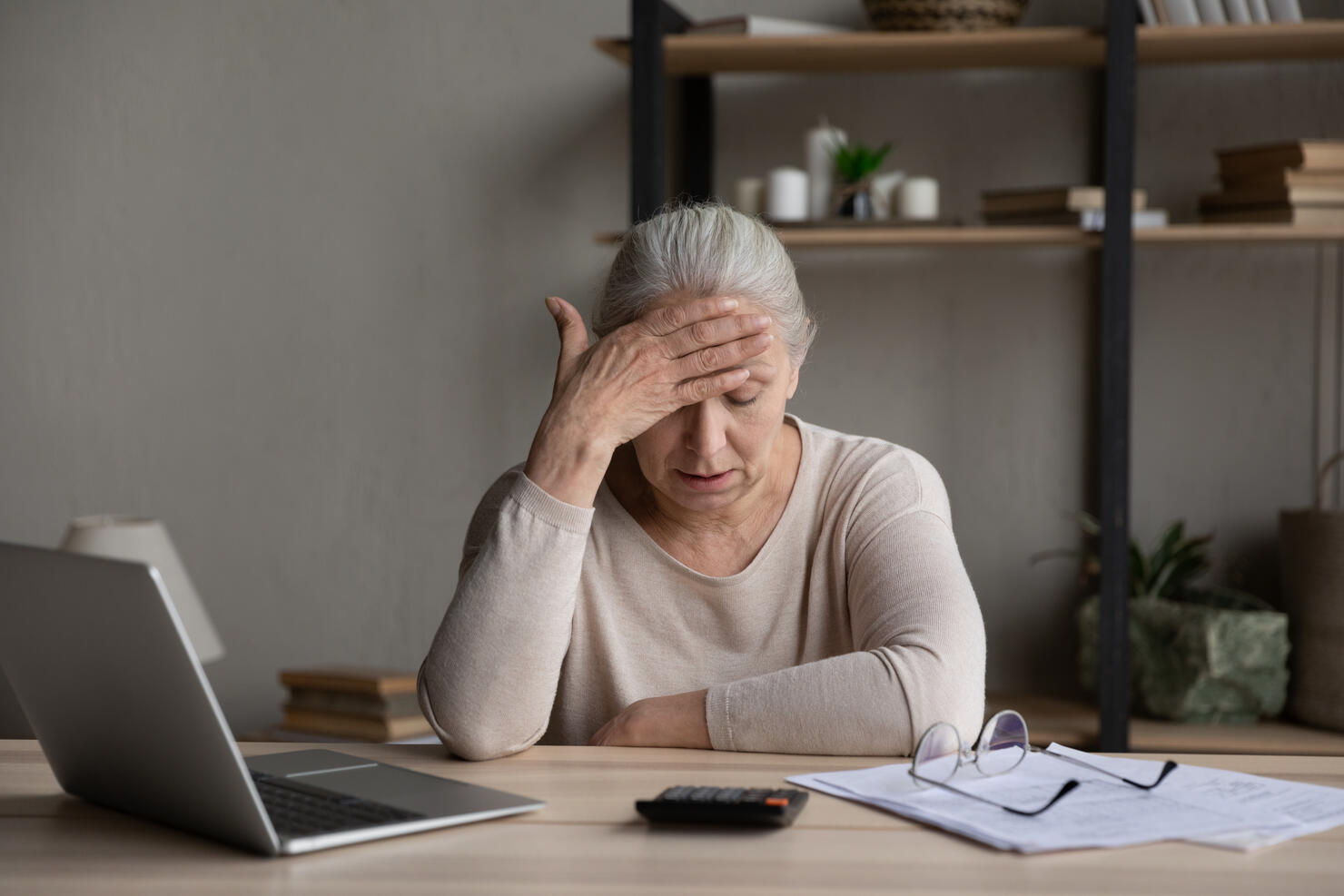 Older woman feels stressed due lack of money pay bills
