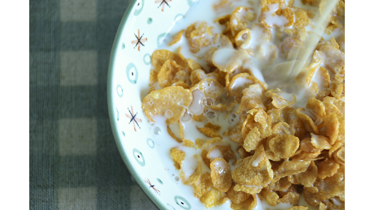 High Angle View of a Bowl of Corn Flakes on a Tosca and White Checkered Pattern Tablecloth