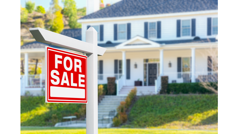For Sale Real Estate Sign in Front of New House.