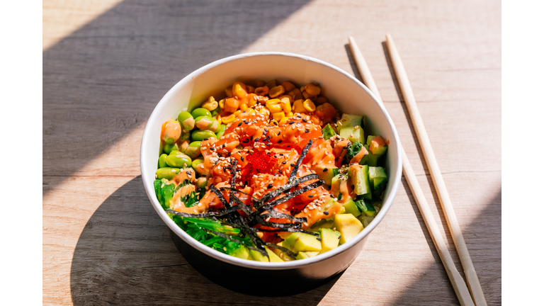 Poke bowl with salmon and edamame beans, side view