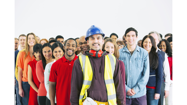 Portrait of confident construction worker and crowd