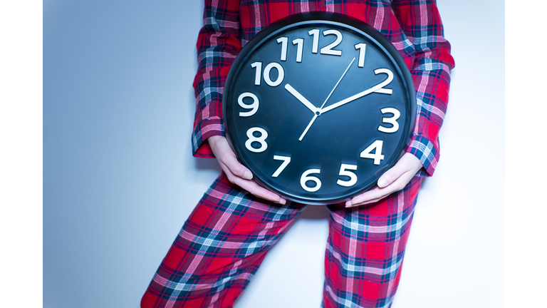 Woman holding clock