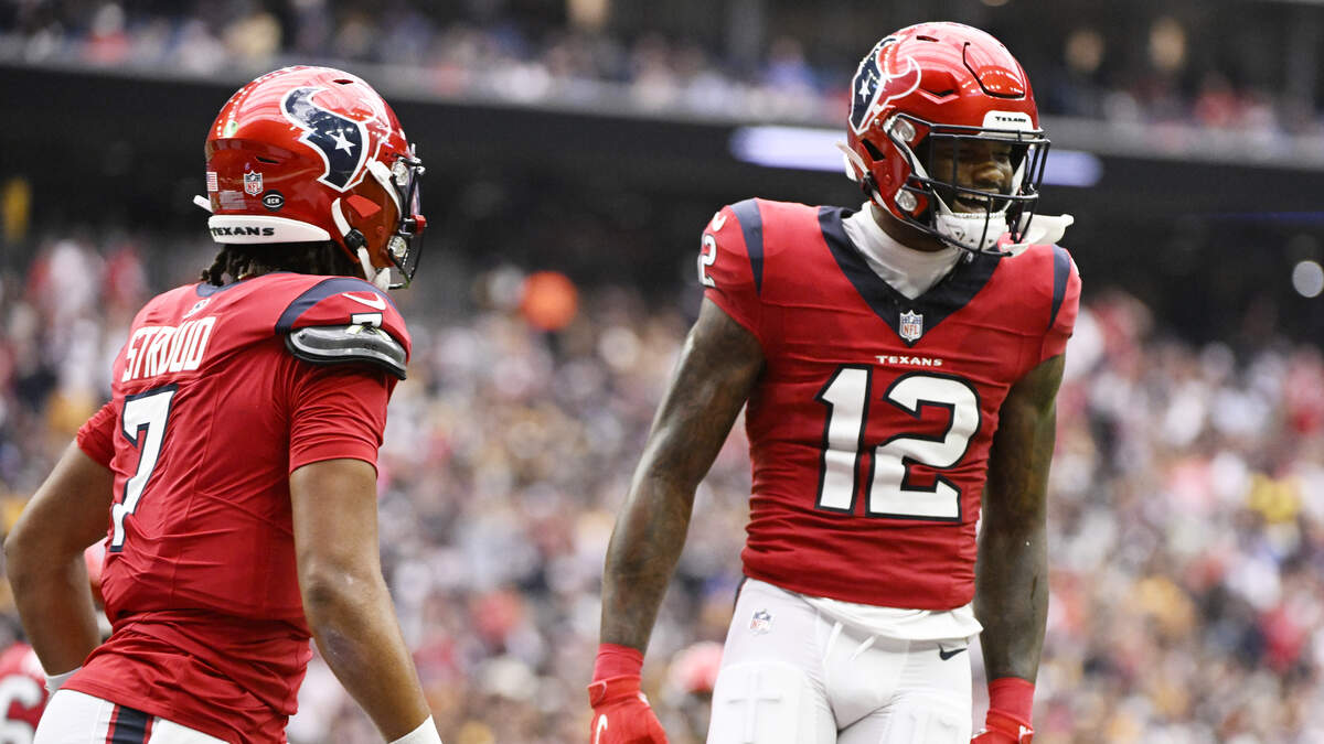 Houston Texans wide receiver Nico Collins (12) carries the ball after a  reception during an NFL football game against the Tennessee Titans, Sunday,  Jan. 9, 2022, in Houston. (AP Photo/Matt Patterson Stock