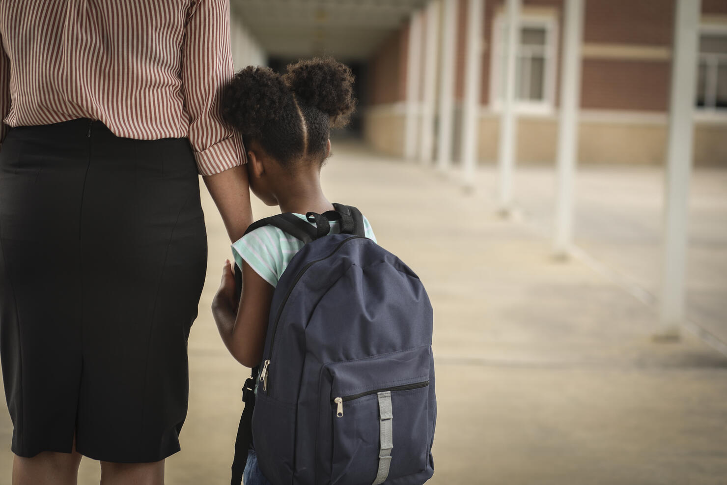 Elementary, African American girl with mom on first day of school.
