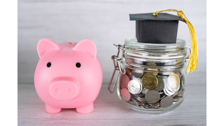 Close-up of coins in jar with piggy bank on table,Romania