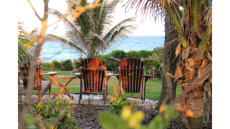 Two empty chairs facing the ocean