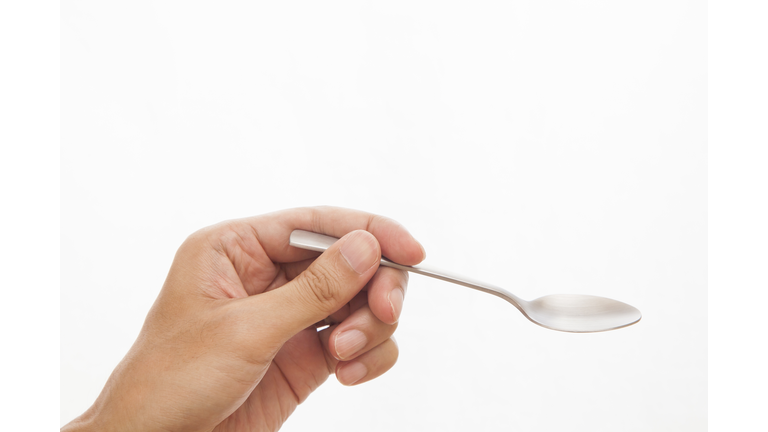 spoon in hand on white background