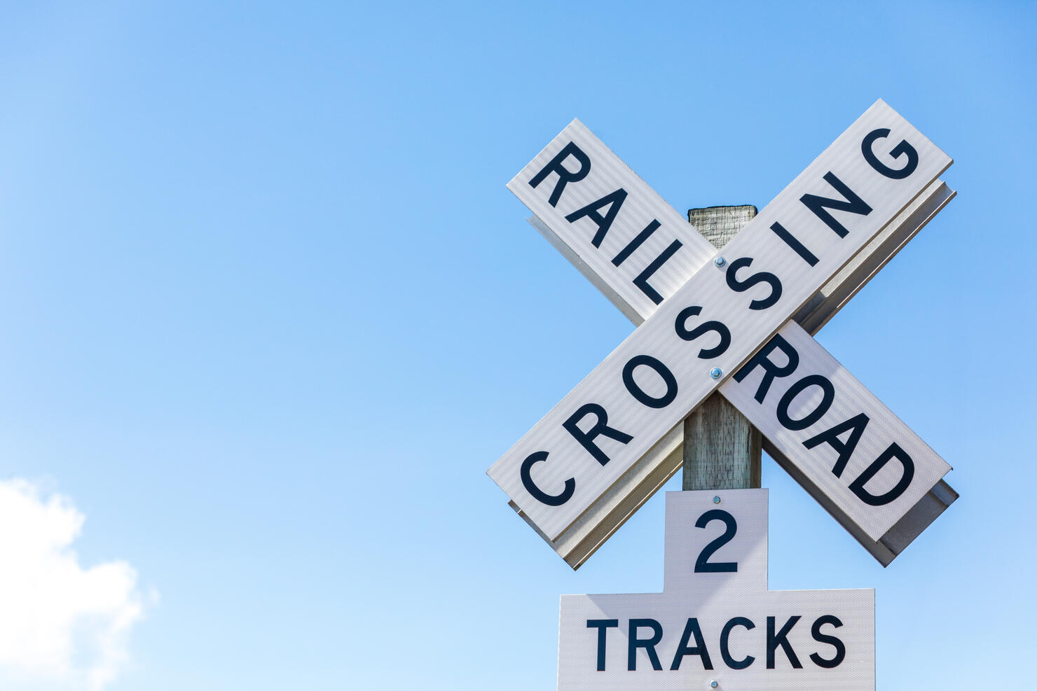 Railroad crossing sign against clear blue sky. Seattle, Washington, USA.